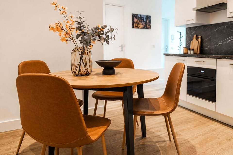 Bright, minimalist kitchen and dining area with a cool, fresh ambiance—ideal for enjoying simple meals in comfort.
