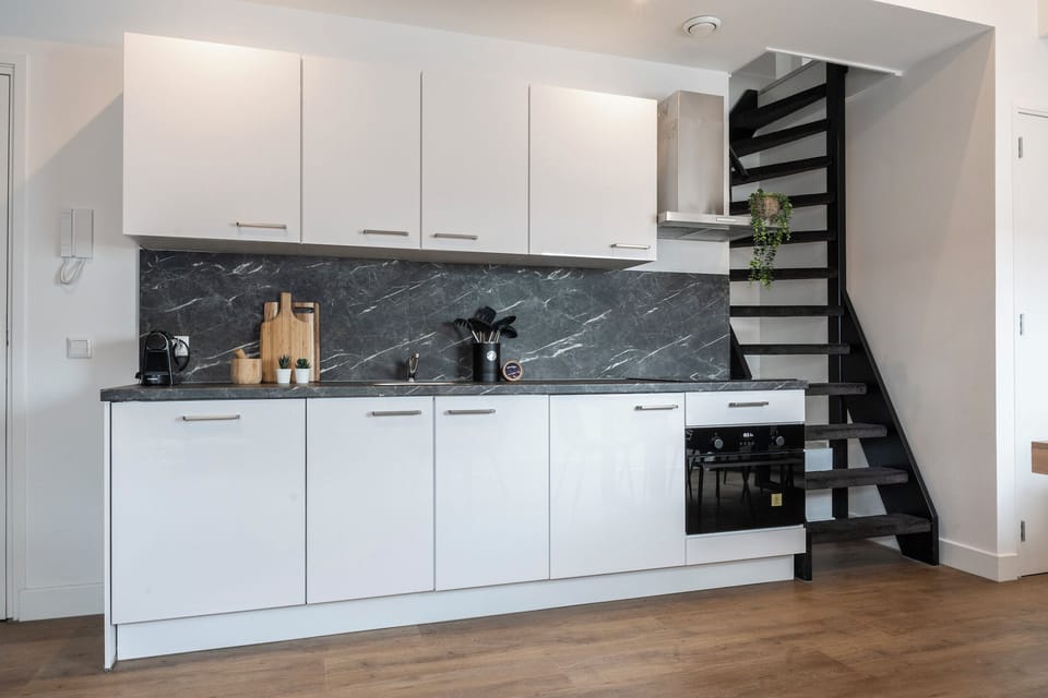A full view of the kitchen displaying a clean, white theme with gray accents, equipped with ample storage and state-of-the-art appliances, blending functionality with style.





A full view of the kitchen displaying a clean, white theme with gray accents, equipped with ample storage and state-of-the-art appliances, blending functionality with style.
