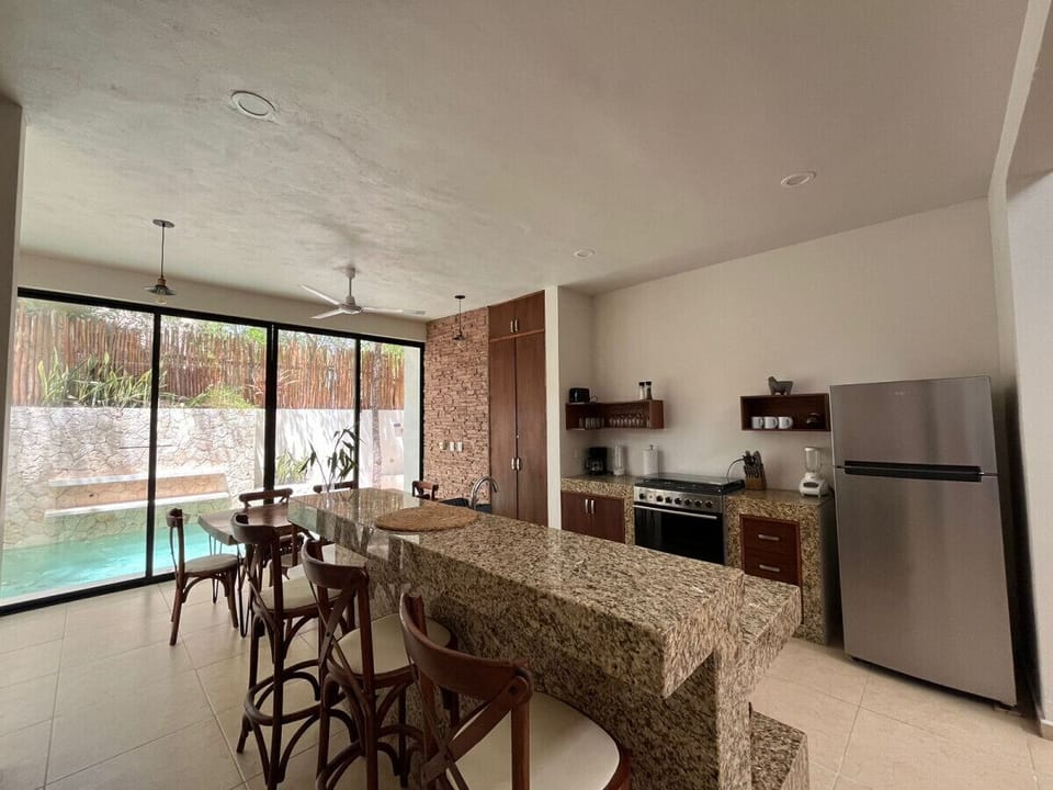 Unleash your inner chef in our luxurious Tulum villa kitchen, complete with an oven, dishwasher, and all the essentials for gourmet adventures