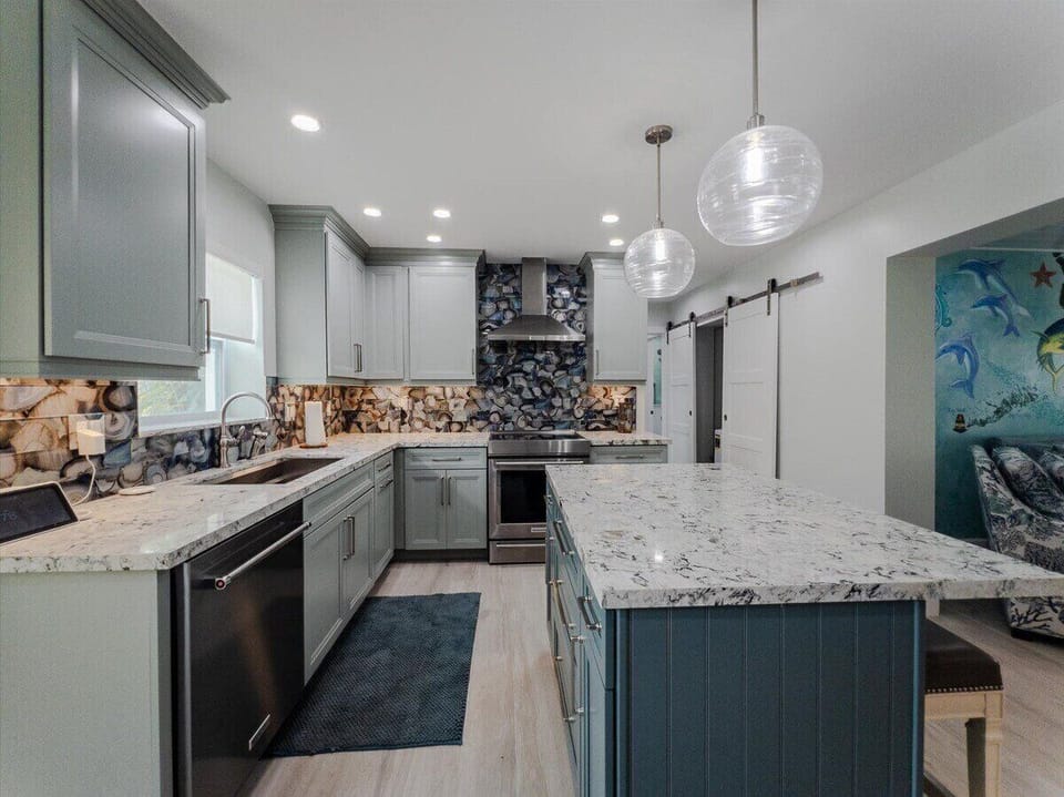Open concept kitchen with ocean views connecting seamlessly to dining and living spaces.