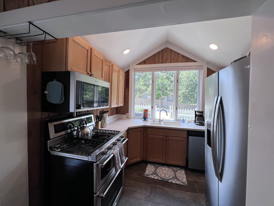 Kitchen has all new appliances and plenty of cleaning supplies under sink.