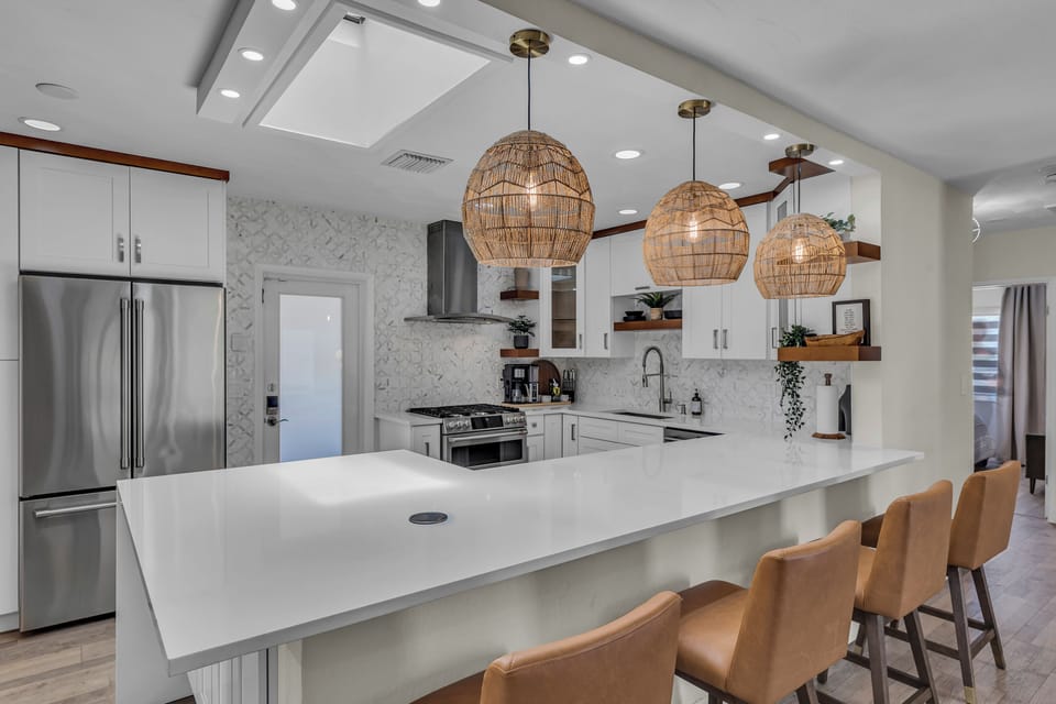 Ample counter space and state-of-the-art appliances in the well-stocked kitchen.