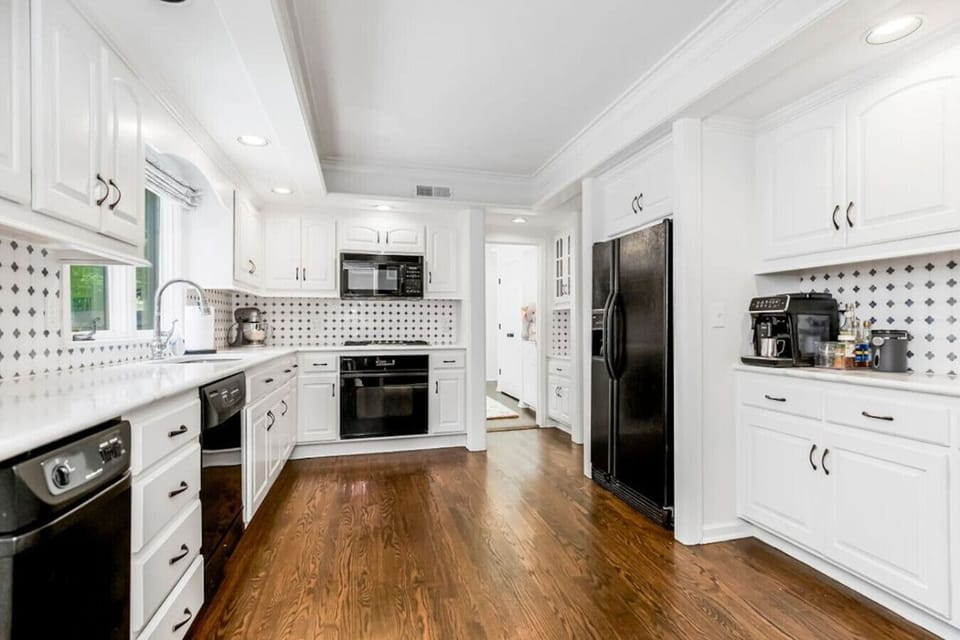 Kitchen: A bright, well-appointed space featuring modern appliances, Wüsthof knives, All-Clad cookware, KitchenAid mixer, and premium essentials for both everyday meals and special occasions.