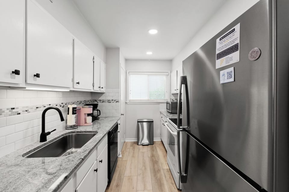 NEWLY Renovated kitchen with slab granite and tile/marble accents