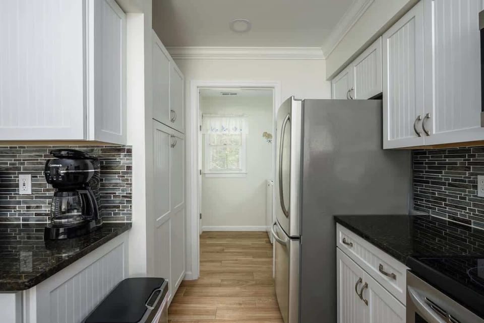 The striking mosaic tile backsplash adds a touch of modern sophistication.