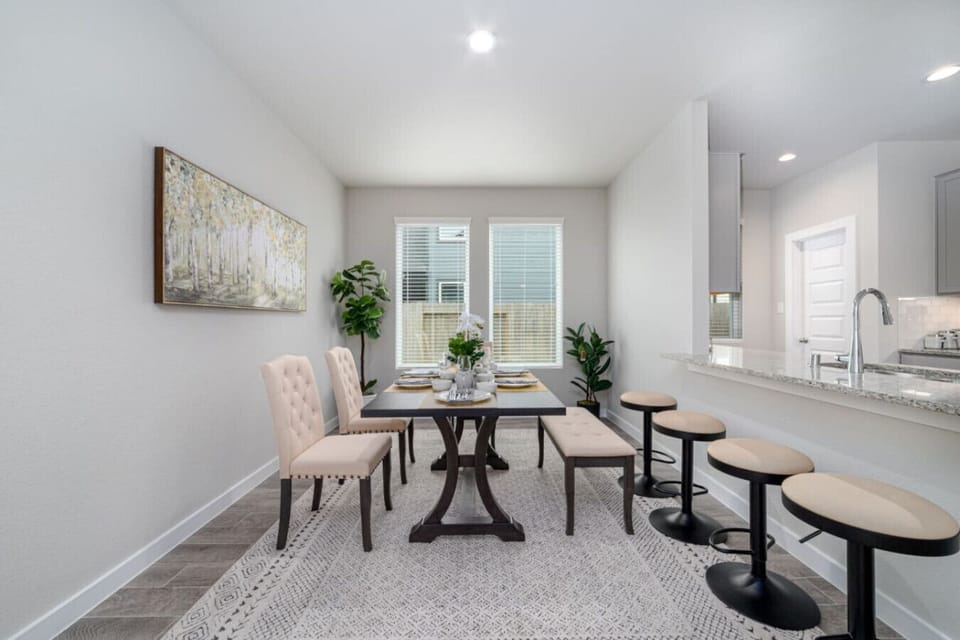 Spacious dining area with ample seating, perfect for meals and gatherings.
