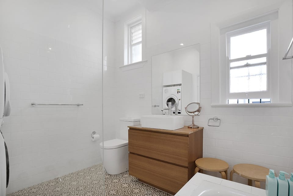 Bathroom with shower over bath and full laundry facilities