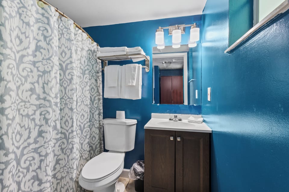 The ensuite bathroom has a tub and shower.