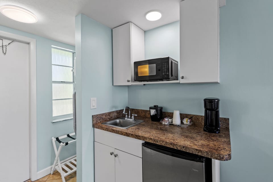 Amenities include a smart TV with cable, a mini fridge, a microwave, and a coffee maker.
