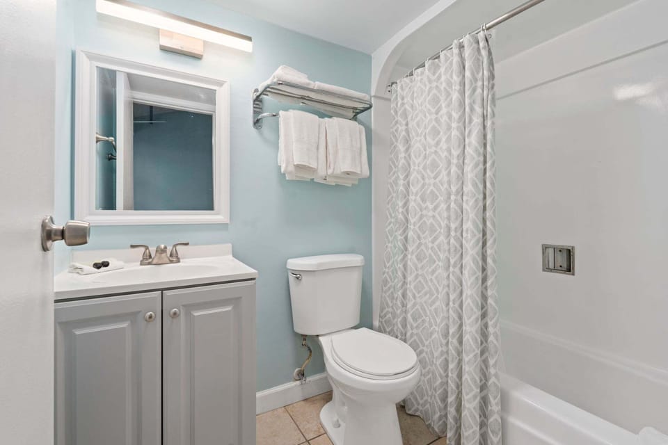 The ensuite bathroom has a tub and shower.