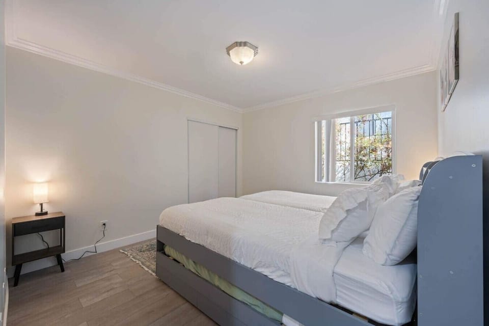 bright and neatly arranged bedroom with twin beds placed side by side