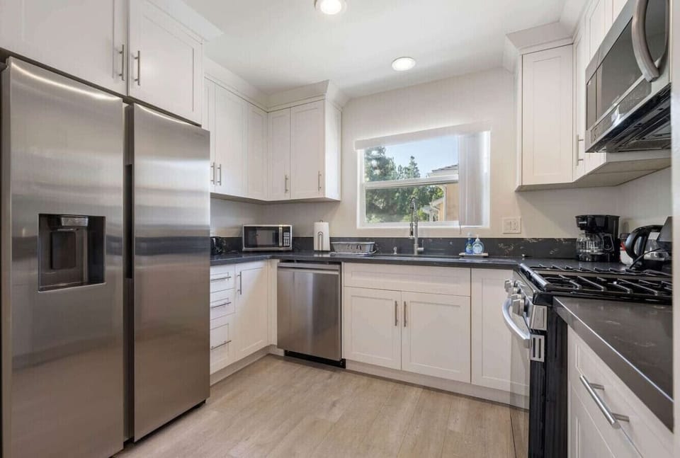 A fully equipped kitchen with updated appliances, natural light, and all essentials you need for cooking or baking during your stay.