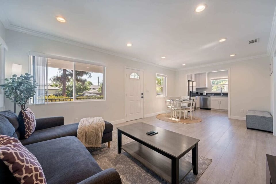 A warm and inviting living area featuring a comfy couch perfect for lounging, watching TV, or relaxing after a long day. The space is designed for comfort and ease, making it ideal for unwinding or spending time together.