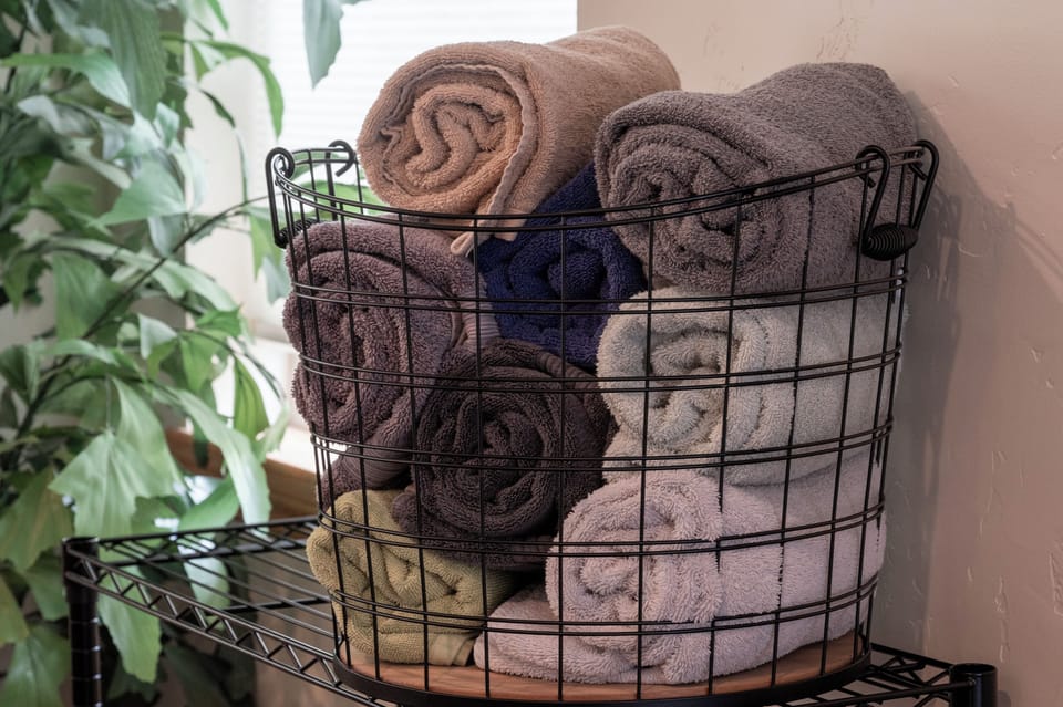 - Basket of fresh towels prepared for guest comfort   - Thoughtful amenities add to cozy cabin retreat   - Ready for relaxing stay after outdoor adventures