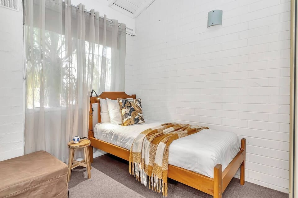 The second bedroom features a comfortable standard single bed, ideal for a child or an additional guest.

