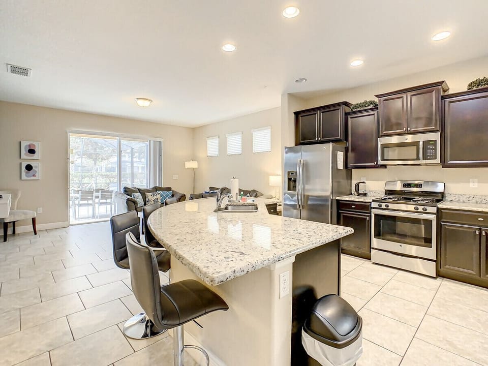 Fully-functional kitchen with dinner and cooking ware, cozy breakfast island