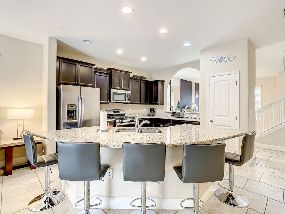 Fully-functional kitchen with dinner and cooking ware, cozy breakfast island