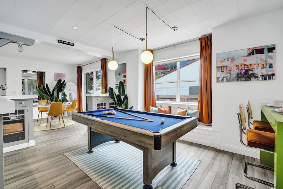 Airy vibes at the pool table area with window ledge seating with deck views