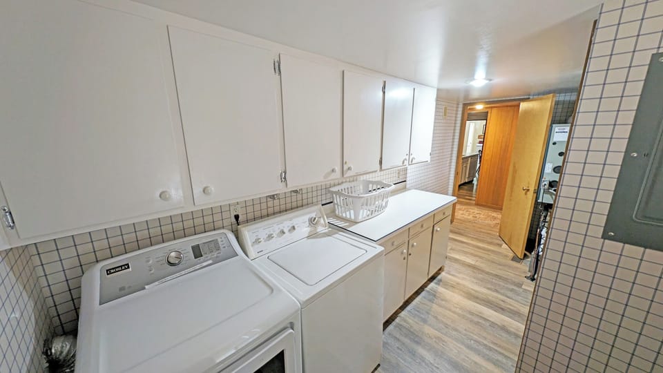 To the left of the entry is the Laundry room which also leads outside.