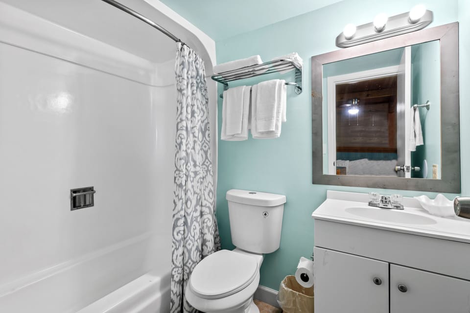 The ensuite bathroom has a tub and shower.
