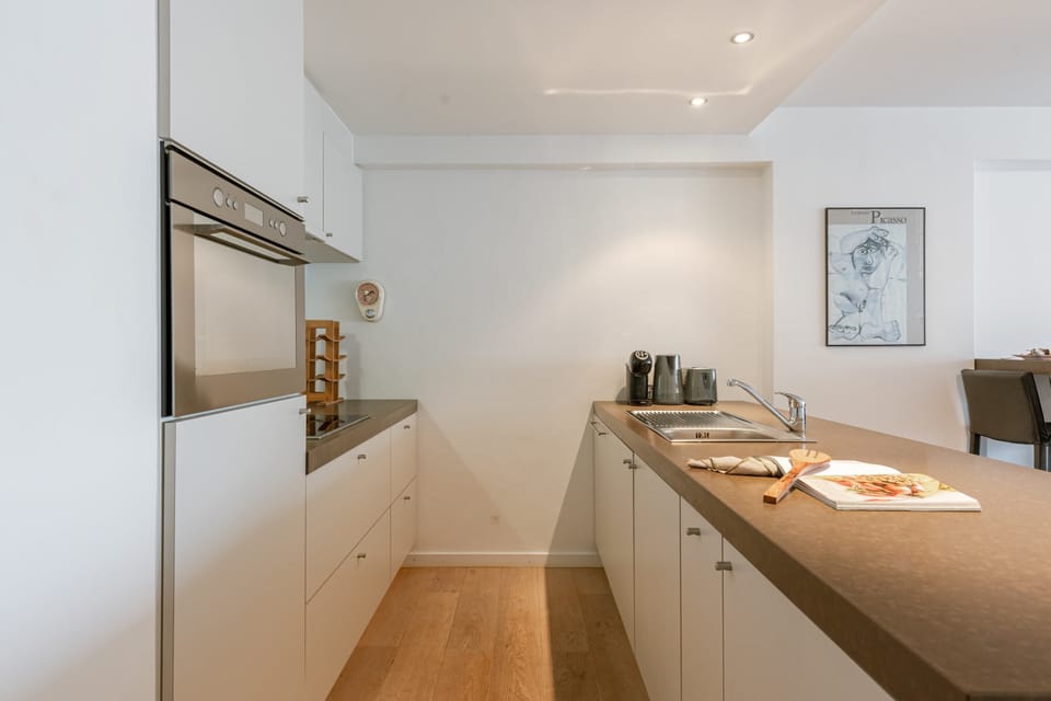 Fully equipped kitchen with oven, stove, and spacious countertops for all your cooking needs.