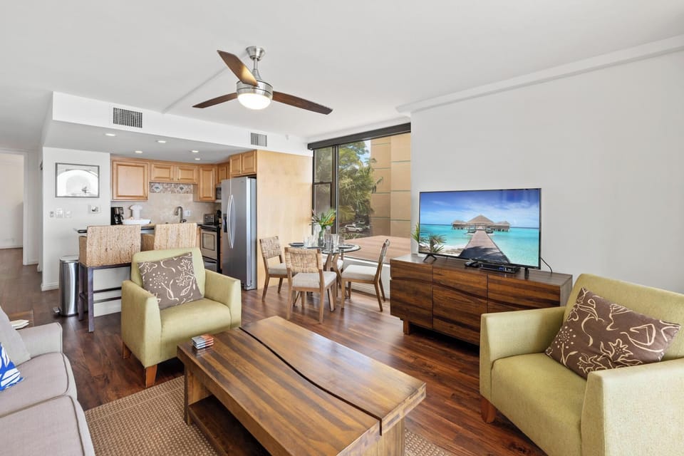 Relax in the open-concept living room with cozy seating, dining area, and a seamless flow to the fully equipped kitchen.