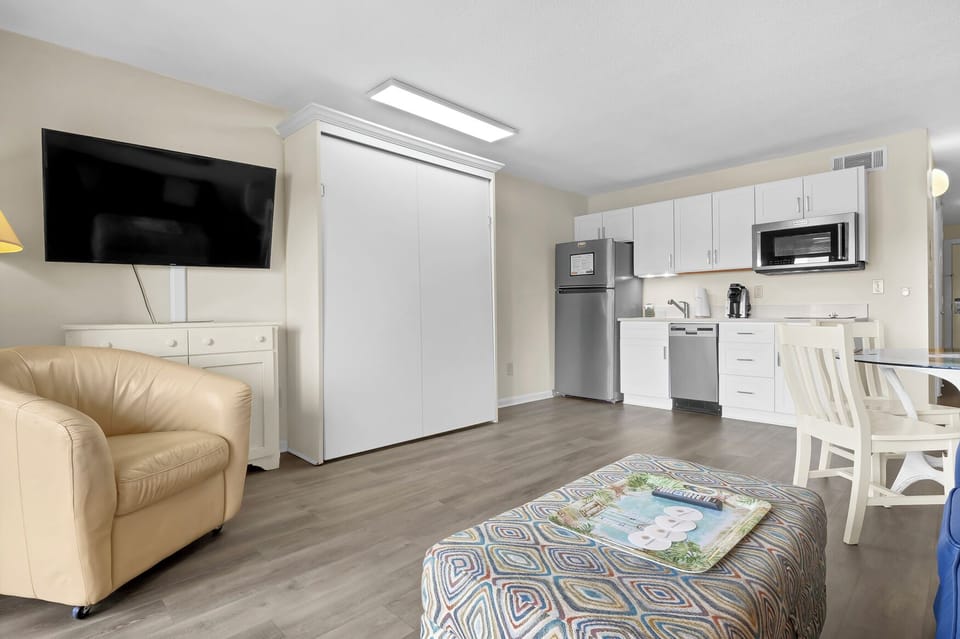 Your bright studio combines comfort and convenience with a full kitchen, cozy seating, and Murphy bed for flexible living.