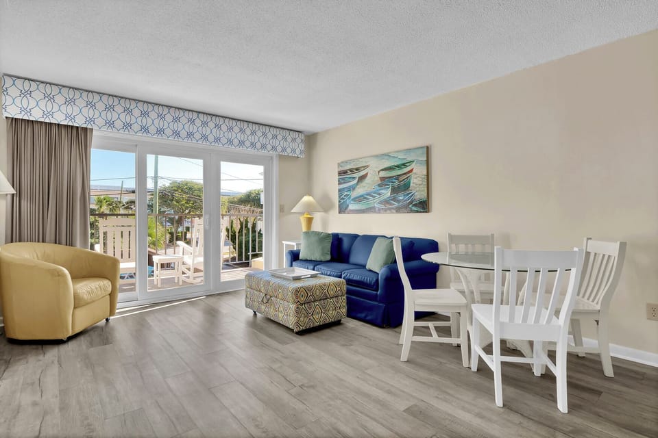 Unwind in your coastal living room with plush seating and dining space, where ocean-inspired decor creates a peaceful retreat.