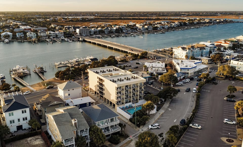 Waterfront property overlooking marina and bridge in coastal community setting.