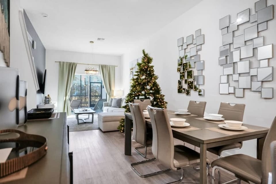 The dining area featured a rustic wooden table surrounded by comfortable chairs, perfect for enjoying meals with family and friends against a backdrop of softly glowing candles.