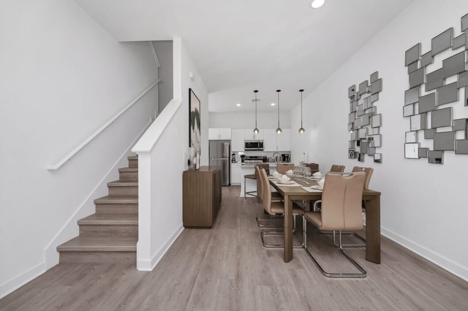 The dining area featured a rustic wooden table surrounded by comfortable chairs, perfect for enjoying meals with family and friends against a backdrop of softly glowing candles.