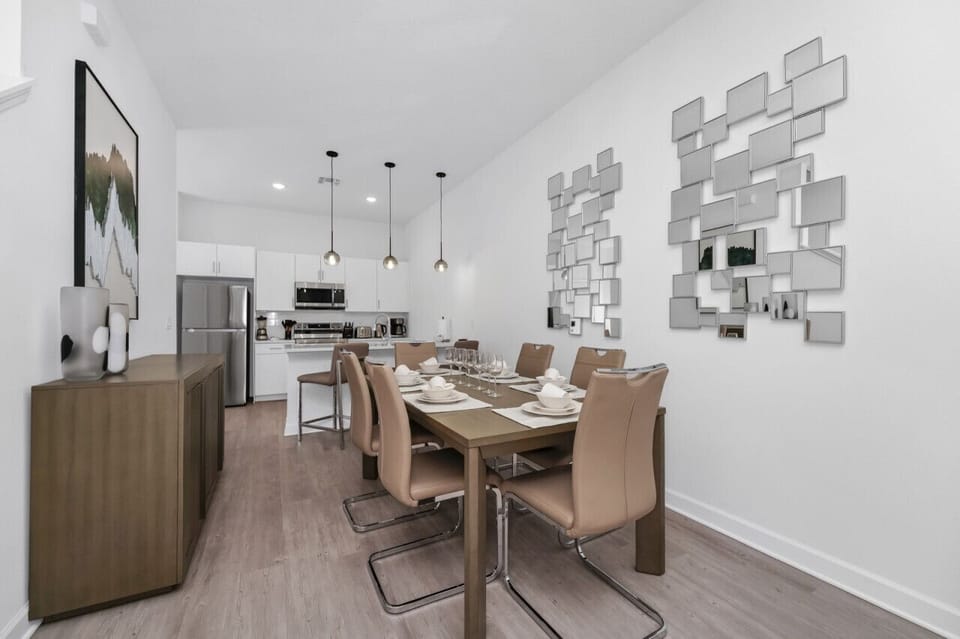 The dining area featured a rustic wooden table surrounded by comfortable chairs, perfect for enjoying meals with family and friends against a backdrop of softly glowing candles.