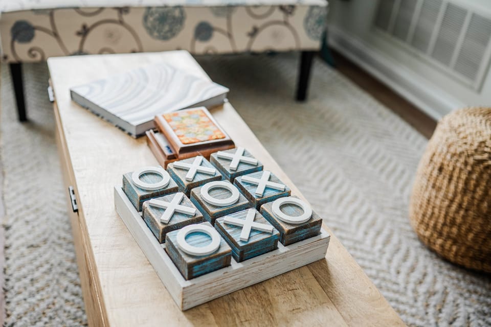 Living room coffee table equipped with cards, games, and books 