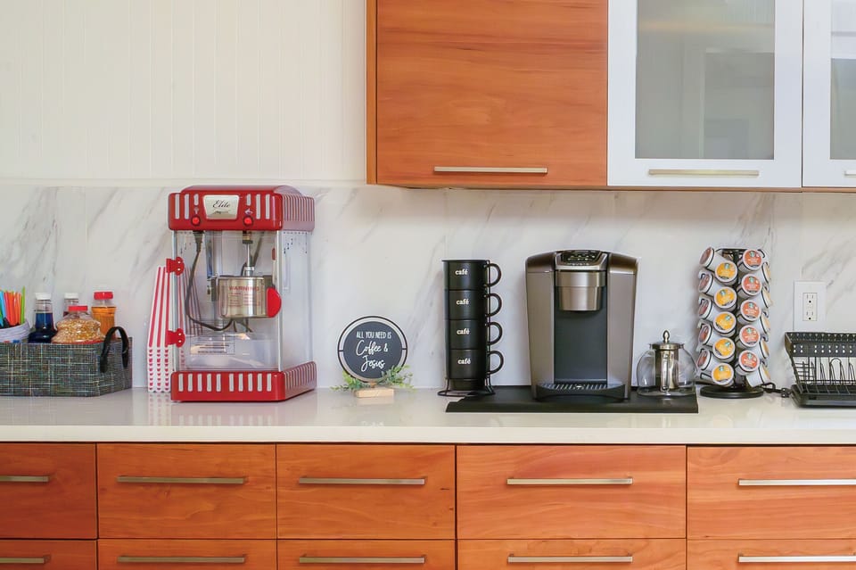 Kitchen is stocked with popcorn machine, snow cone machine and coffee machine.
