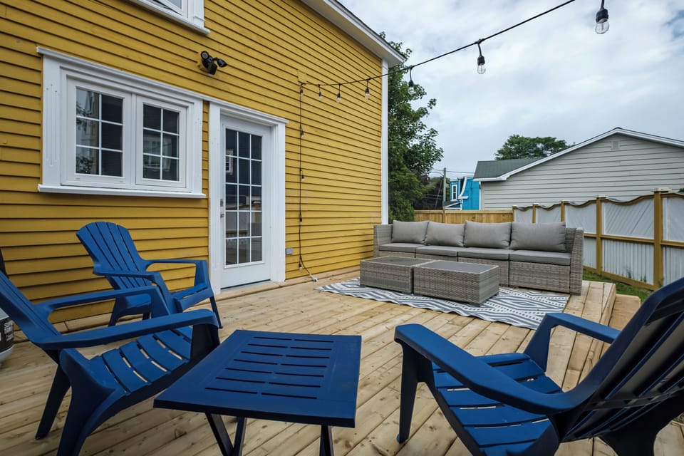 Fully fenced yard with a spacious deck, perfect for relaxing or enjoying meals outdoors.