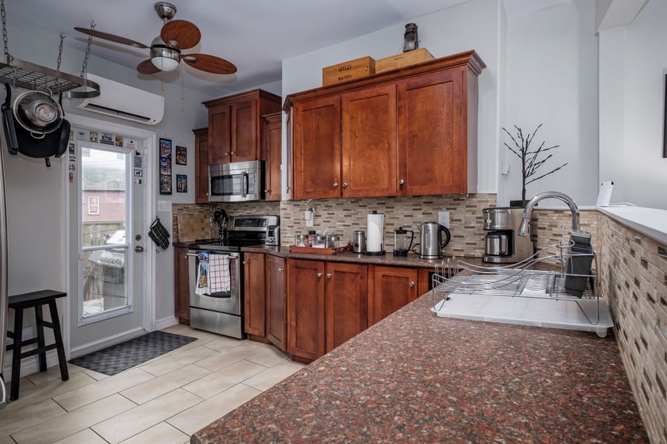 Spacious, fully equipped kitchen, with plenty of amenities provided for your stay.