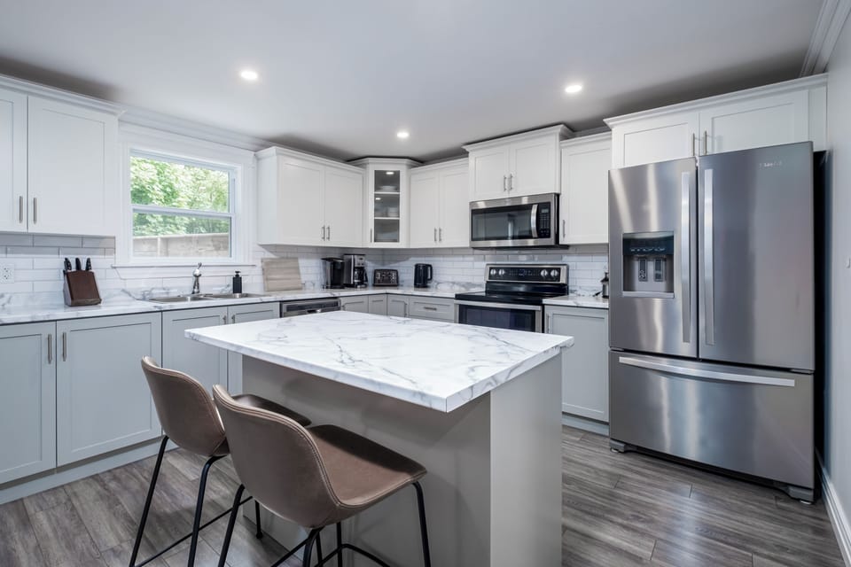 Expansive modern kitchen with high-end appliances, sleek cabinetry, and generous counter space.