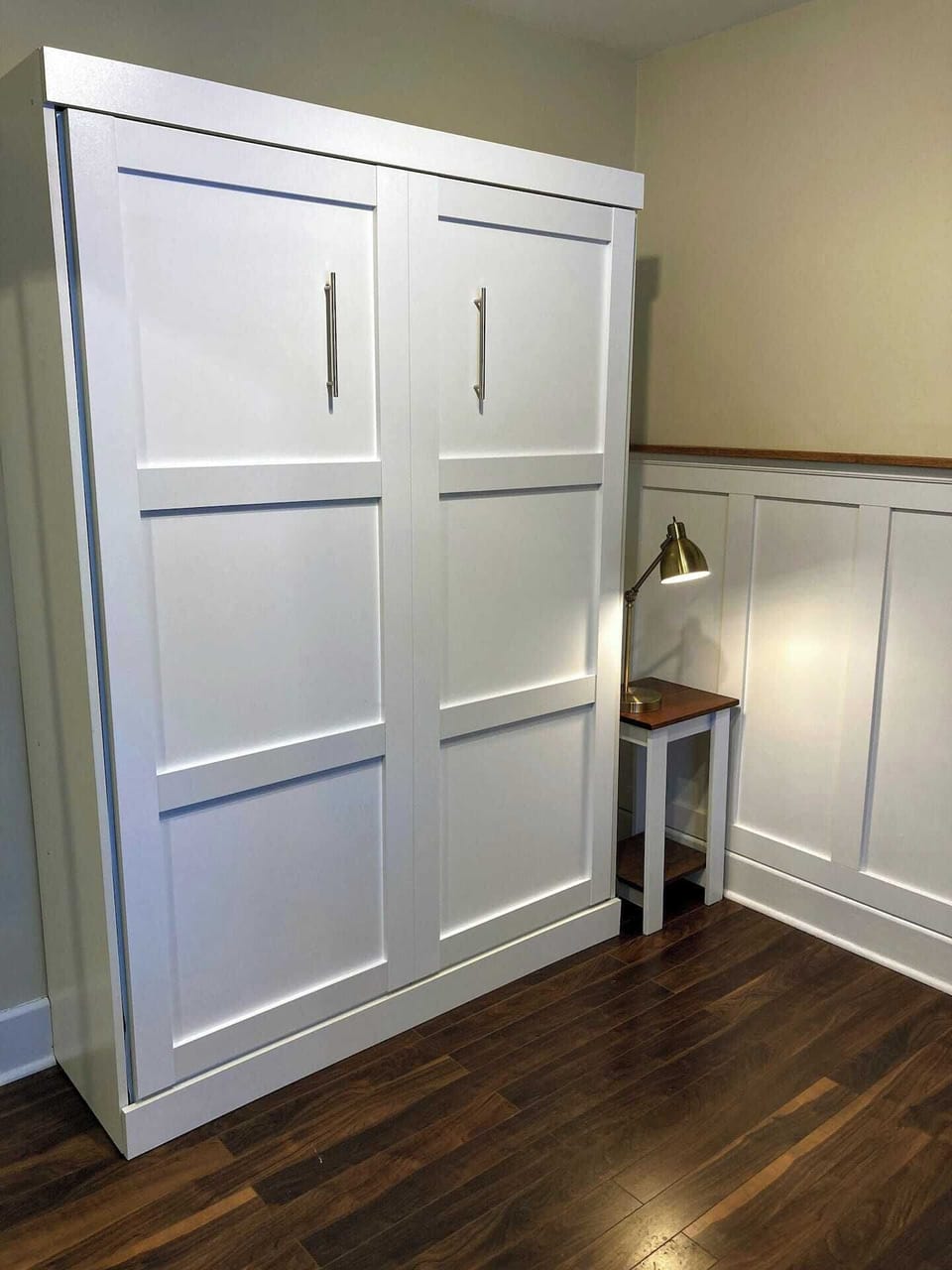 A multi-purpose room featuring exercise equipment and murphy bed.