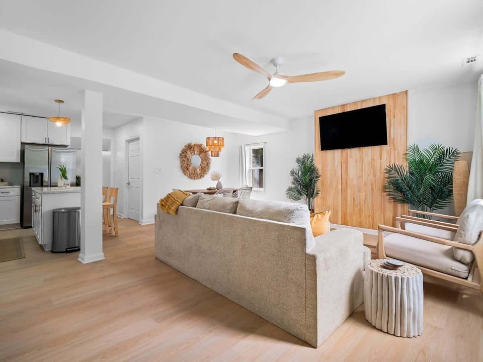 - Open-concept living space with cozy seating and bright décor   - Large sofa and armchairs arranged for comfort and gatherings   - Airbnb layout designed for entertainment and relaxation  