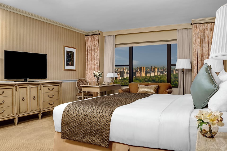Wake up to breathtaking city views from plush, serene bedding.