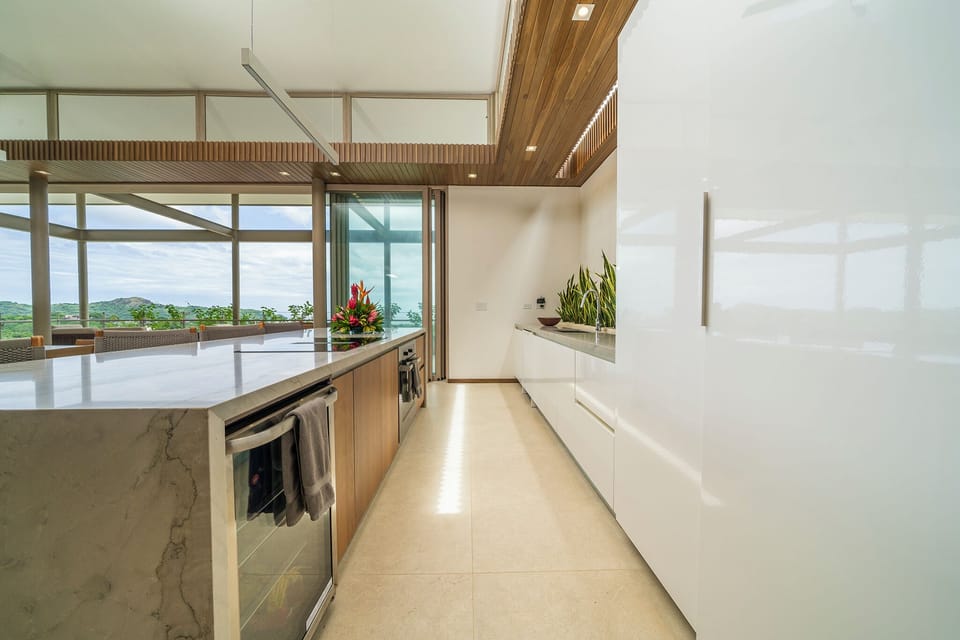 Kitchen has Miele cooktop/oven/dishwasher and wine/beverage refrigerator.