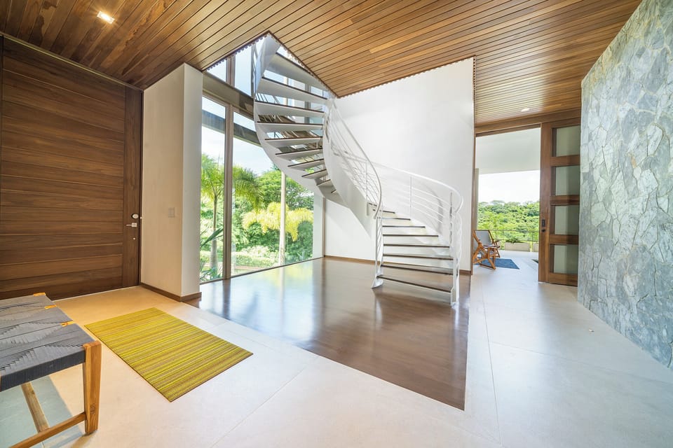 Main staircase leads up to the main level.  Pool deck through door to the right.