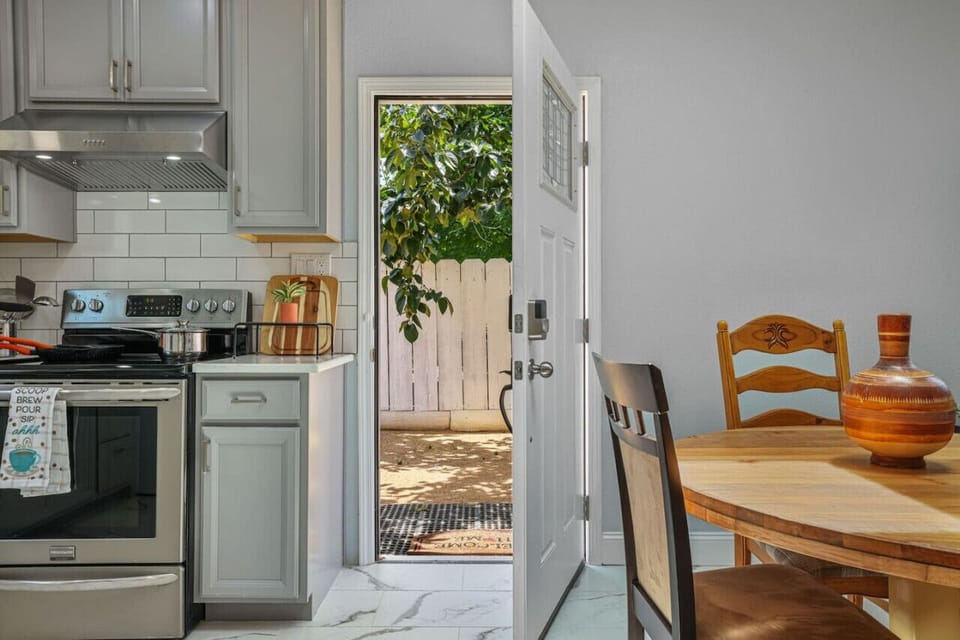 **Inviting Kitchen with Patio Access**  Enjoy our inviting kitchen, complete with modern appliances and a charming dining area. Step outside to the patio for fresh air and relaxation. Ideal for cooking meals and enjoying your stay. Book now for a cozy, co