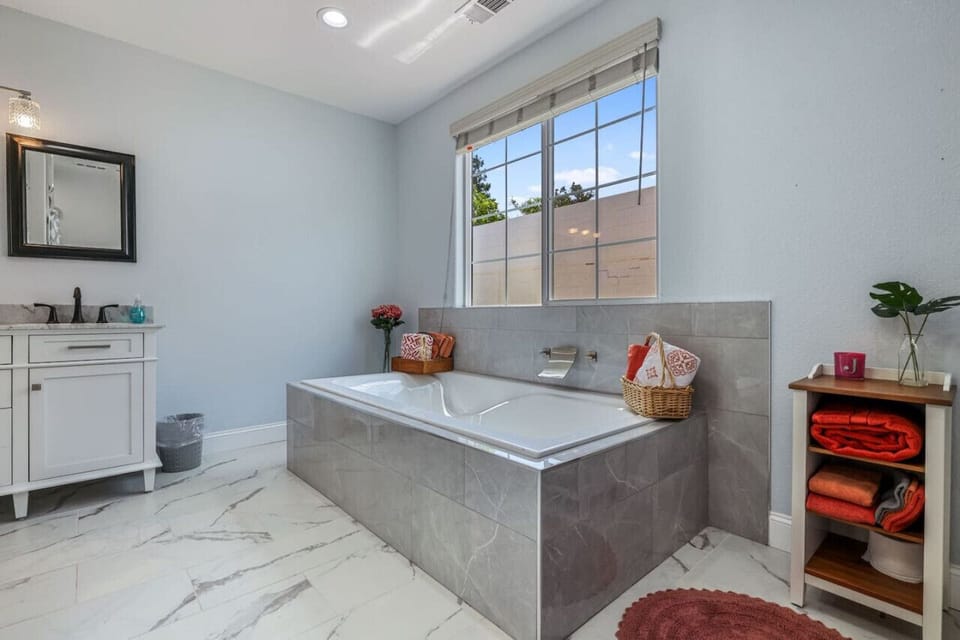 **Elegant Spa-Like Bathroom**  Indulge in luxury with our elegant spa-like bathroom. Featuring a spacious soaking tub with a modern faucet, double vanity, and chic decor, it`s perfect for relaxation and rejuvenation. Book now for a serene and pampering ex