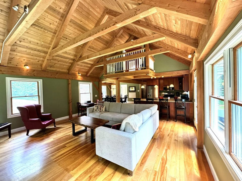 Living Room with wood burning fireplace, 55` Smart TV