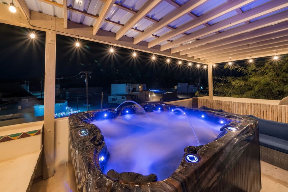 Experience the ultimate rooftop soak in a glowing, oversized jacuzzi with custom jets and ambiance lighting.