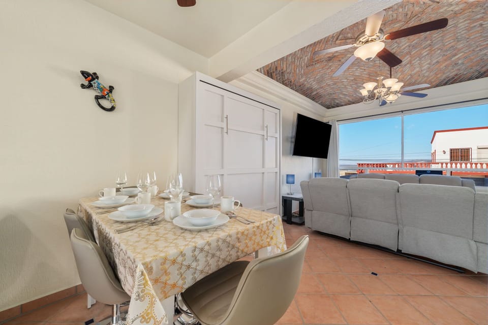 Open-concept dining and living area with Murphy bed concealed ideal for relaxing or entertaining with ocean views.
