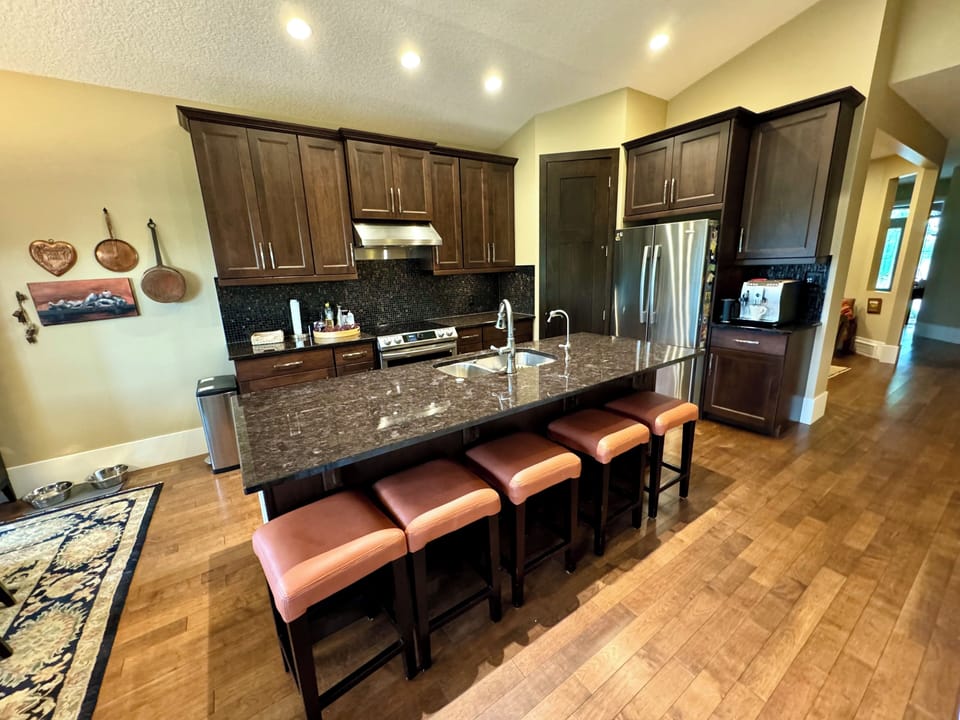 Kitchen with induction stove. Microwave is at the end of the island