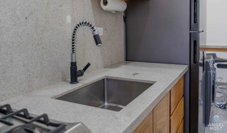 This kitchen features a large sink, ideal for fast and easy clean-ups.