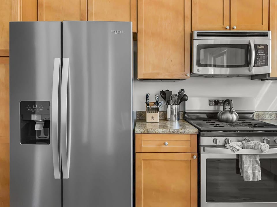 - Stainless steel refrigerator, gas range, and microwave offer modern convenience - Fully equipped setup for preparing anything from quick breakfasts to full dinners - Granite counters and wood cabinets complete the cozy kitchen space